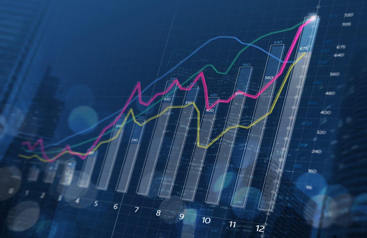 Business growth, progress or success concept. Financial bar chart and growing graphs with depth of field on dark blue background.